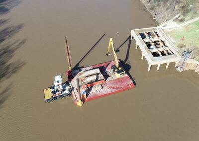 EXCAVATOR PLACES RIPRAP IN BRAZOS